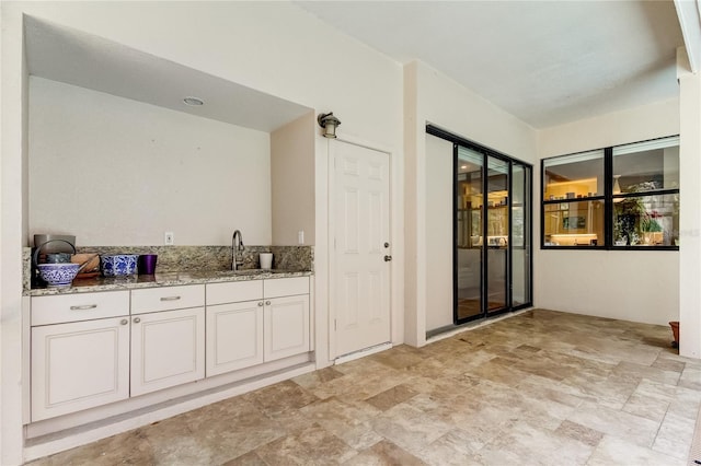 view of patio featuring exterior kitchen and a sink