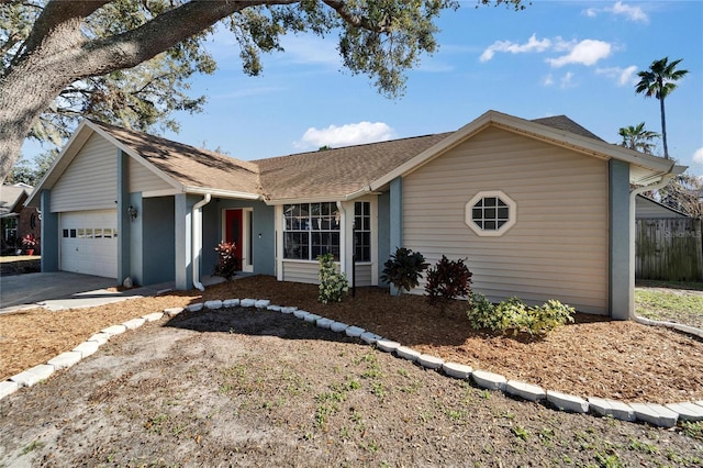 single story home with a garage, fence, and roof with shingles