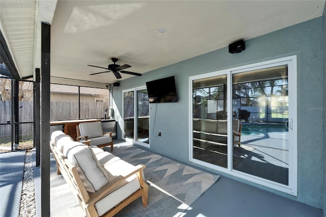 view of patio / terrace with fence and a ceiling fan