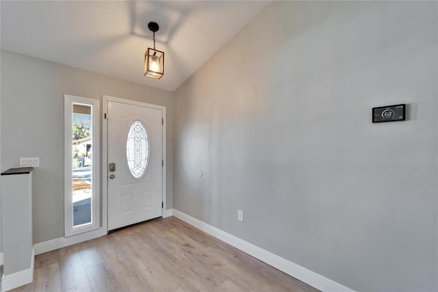 entryway featuring light wood-style flooring and baseboards