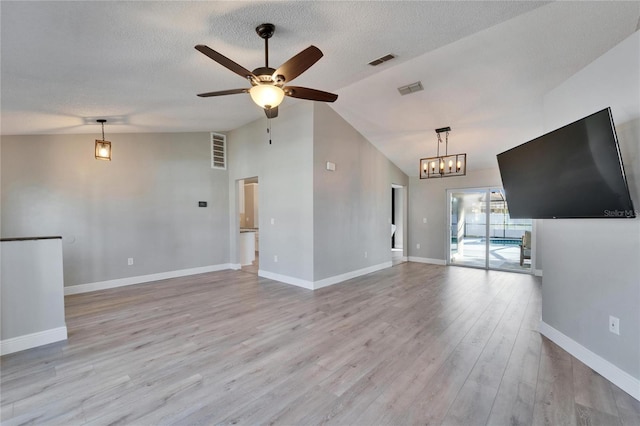 unfurnished living room featuring light wood finished floors, visible vents, and a textured ceiling