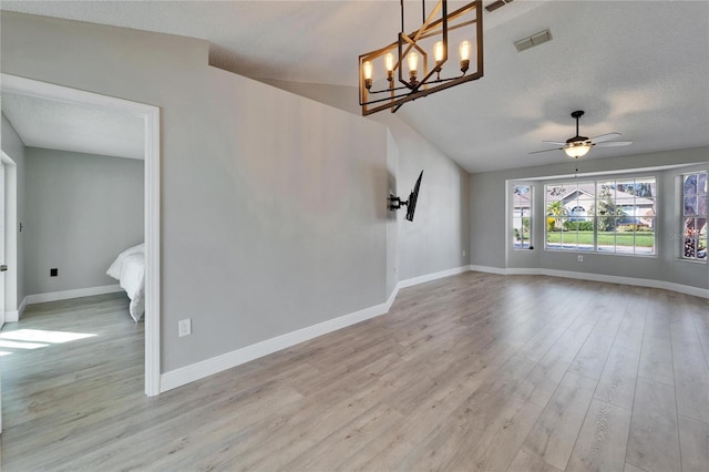 unfurnished room featuring baseboards, a textured ceiling, visible vents, and light wood-style floors