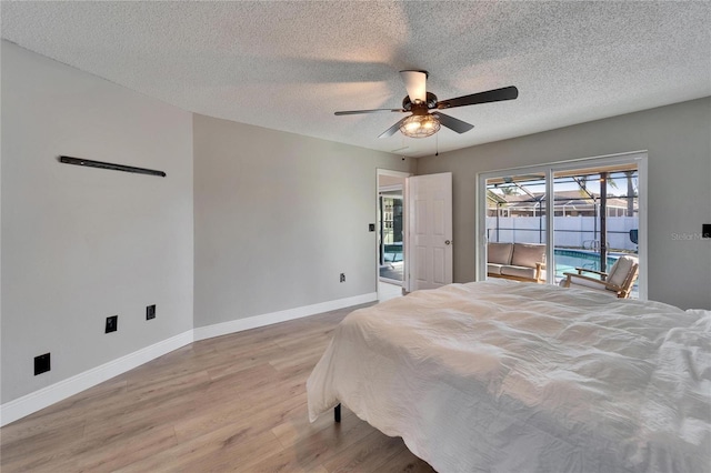 bedroom featuring a sunroom, ceiling fan, a textured ceiling, light wood-type flooring, and baseboards