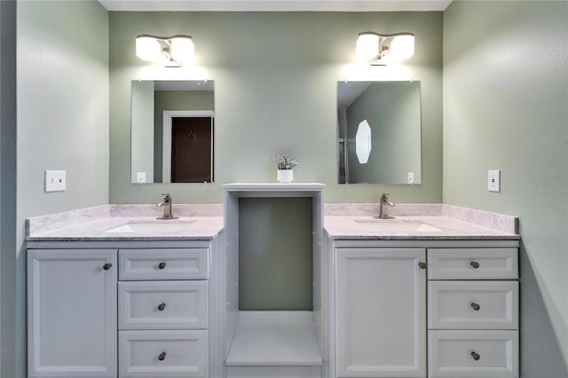 bathroom featuring two vanities and a sink