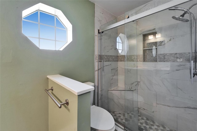 bathroom featuring a shower stall and toilet