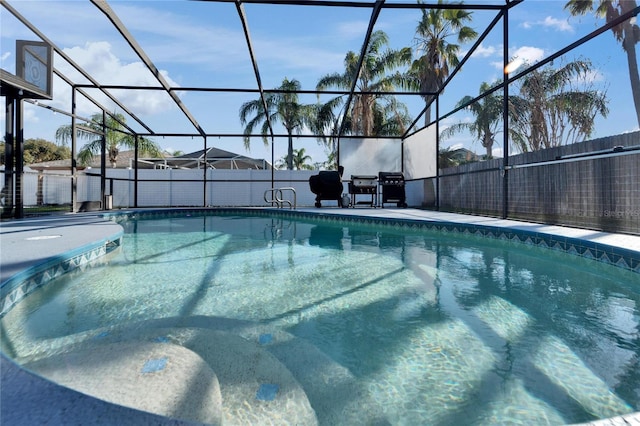 view of pool with grilling area, a lanai, a fenced in pool, and fence