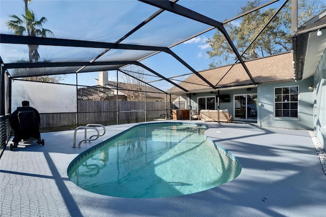 view of swimming pool with a fenced in pool, glass enclosure, a patio, and fence