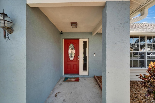 property entrance featuring stucco siding