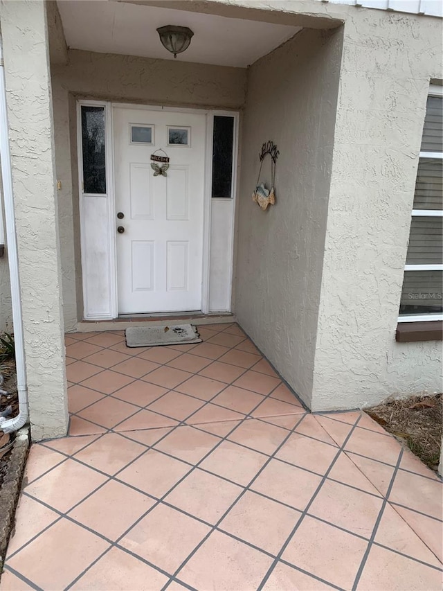 entrance to property with stucco siding