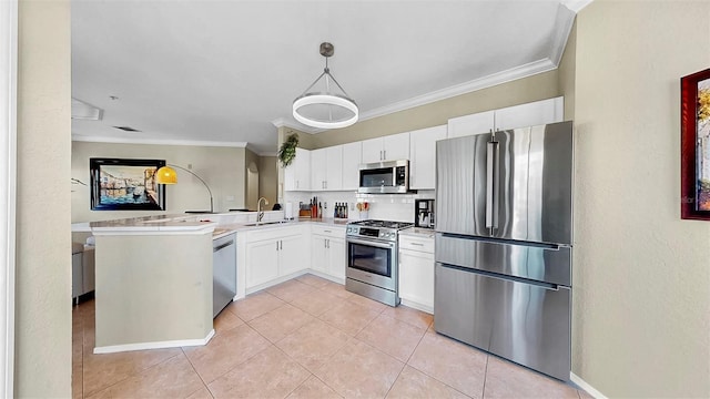 kitchen featuring pendant lighting, light countertops, appliances with stainless steel finishes, white cabinetry, and a peninsula