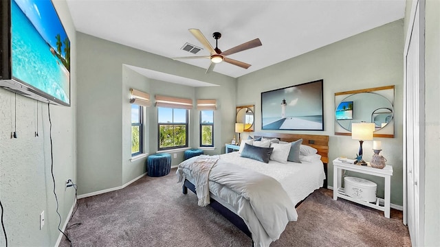 bedroom with baseboards, visible vents, dark colored carpet, and a ceiling fan