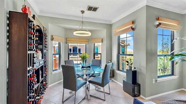 dining area with ornamental molding, visible vents, baseboards, and light tile patterned floors