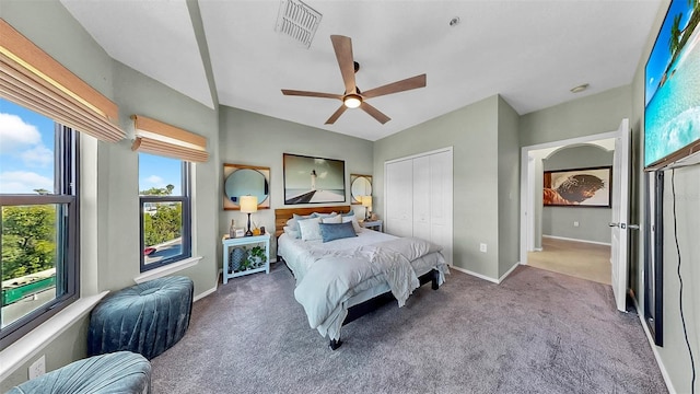 bedroom with carpet flooring, a ceiling fan, visible vents, baseboards, and a closet