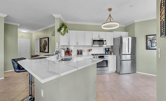 kitchen with light tile patterned flooring, a sink, white cabinetry, hanging light fixtures, and appliances with stainless steel finishes