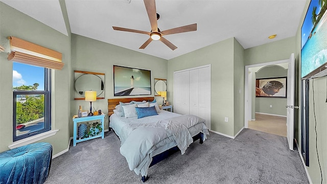 bedroom featuring a closet, carpet flooring, vaulted ceiling, ceiling fan, and baseboards