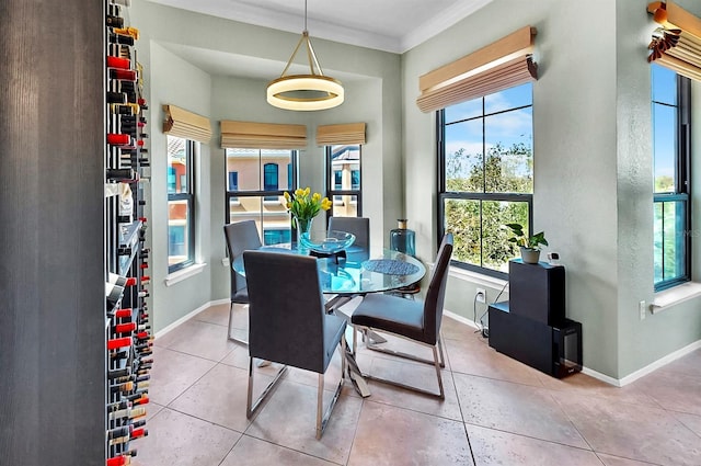 tiled dining area featuring ornamental molding and baseboards