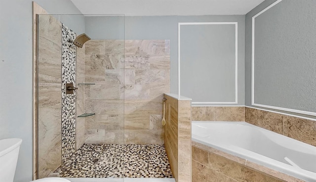 full bathroom featuring tiled shower, a garden tub, and toilet