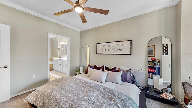 bedroom featuring ensuite bathroom, ceiling fan, light carpet, baseboards, and crown molding