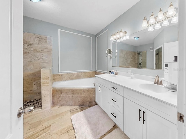 bathroom featuring a sink, a bath, and a walk in shower