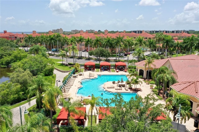 community pool with fence and a patio