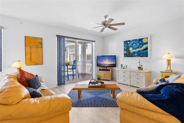 living area with light wood finished floors, baseboards, and a ceiling fan