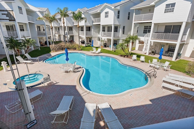 pool featuring a residential view and a patio