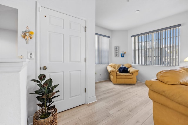 sitting room with light wood finished floors and baseboards