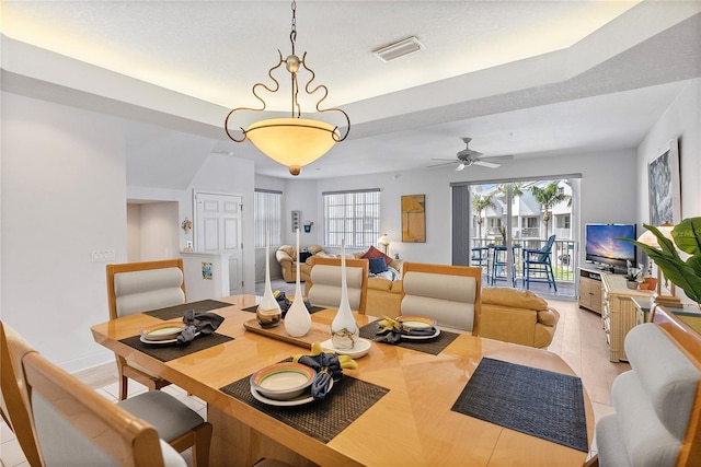 dining space featuring baseboards, visible vents, and a ceiling fan