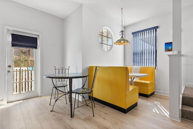 dining area featuring baseboards and wood finished floors