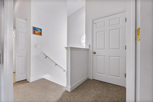 stairs featuring carpet flooring and baseboards