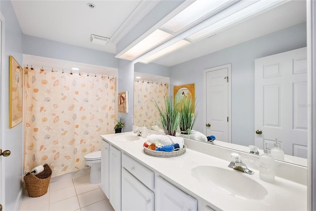 bathroom featuring double vanity, a sink, toilet, and tile patterned floors