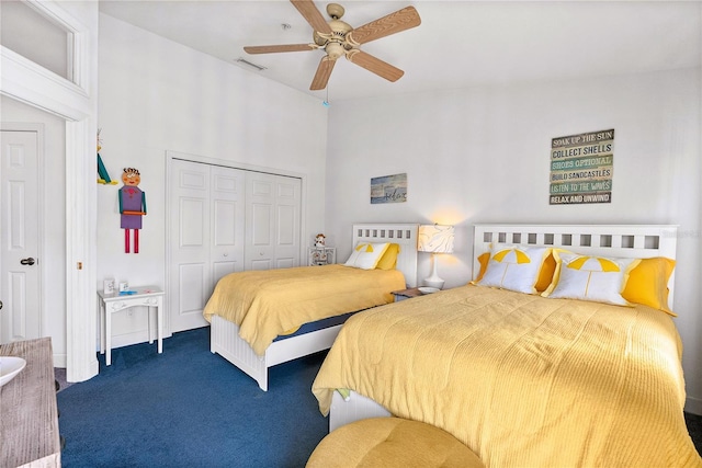 carpeted bedroom featuring a ceiling fan, visible vents, and a closet