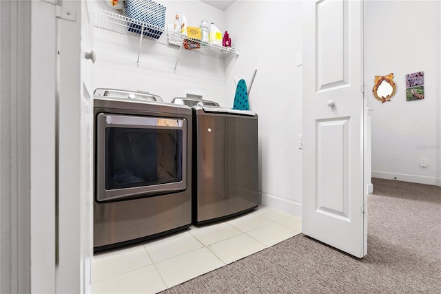 washroom with carpet floors, washing machine and clothes dryer, tile patterned flooring, laundry area, and baseboards