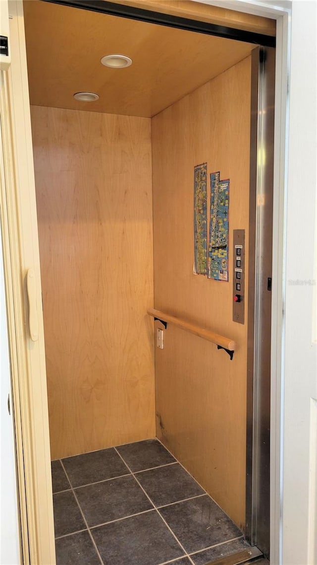 125 Shoals Cir N, Redington Beach, FL 33708 - hall with elevator, dark tile patterned flooring, and recessed lighting