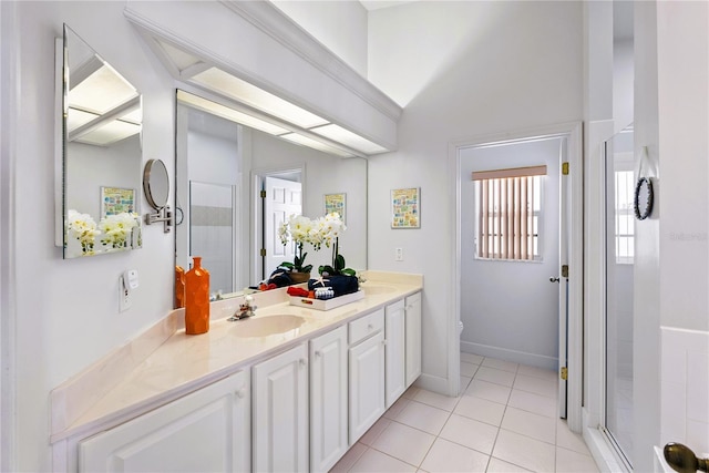 125 Shoals Cir N, Redington Beach, FL 33708 - bathroom with double vanity, tile patterned floors, a stall shower, and lofted ceiling