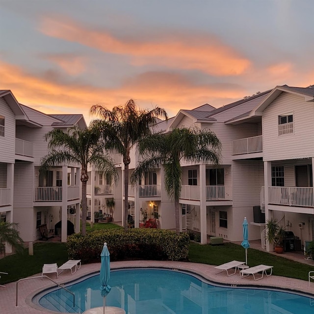 125 Shoals Cir N, Redington Beach, FL 33708 - pool at dusk with a community pool and a lawn