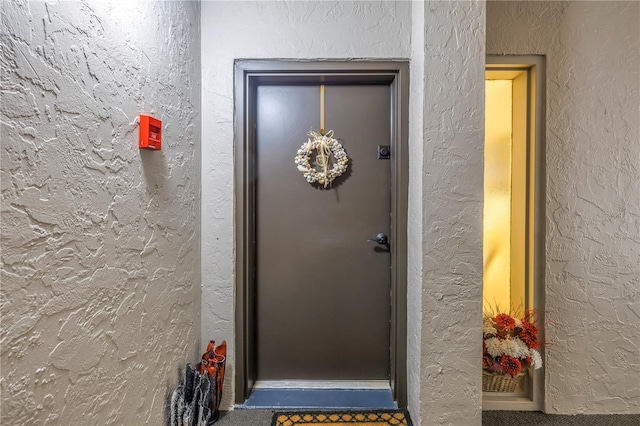 entrance to property featuring stucco siding