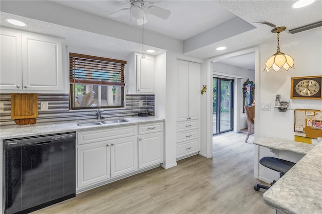 kitchen with a sink, decorative backsplash, light countertops, and dishwasher