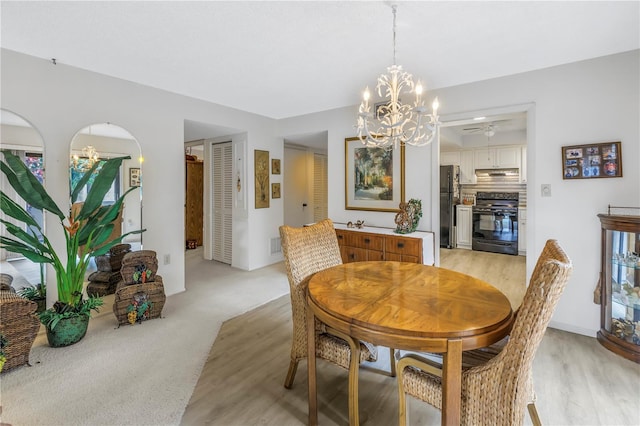 dining area with visible vents, a notable chandelier, and light colored carpet