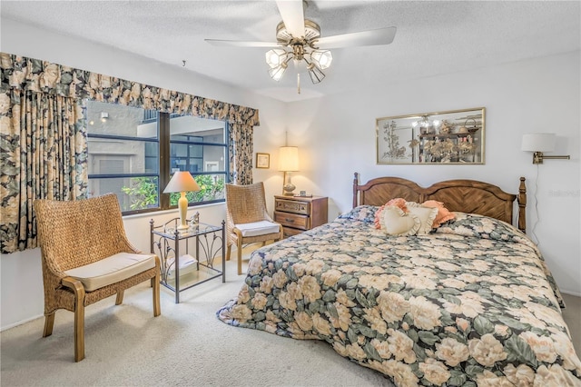 carpeted bedroom with ceiling fan and a textured ceiling