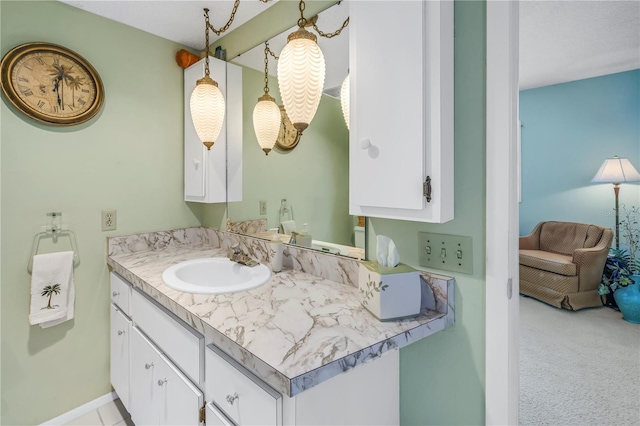 bathroom with baseboards, ensuite bathroom, and vanity