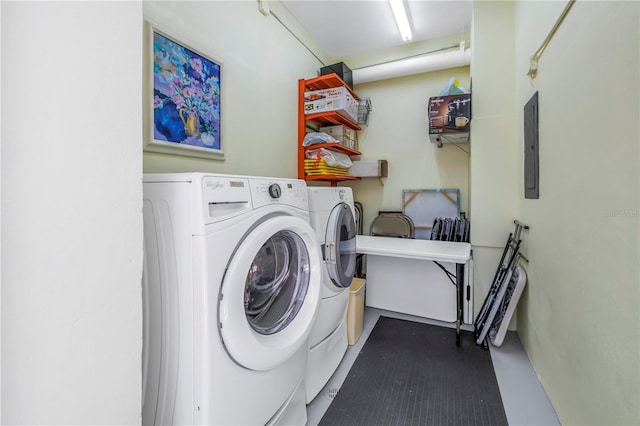 laundry area featuring laundry area, electric panel, and separate washer and dryer