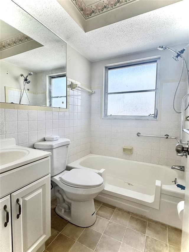 full bath featuring vanity, tile patterned flooring, tile walls, and a healthy amount of sunlight