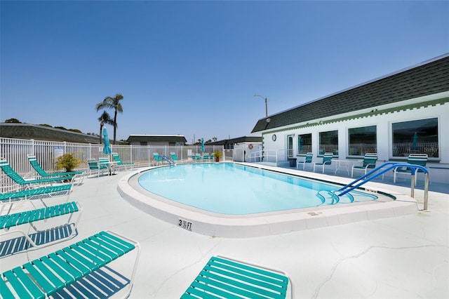community pool featuring a patio and fence