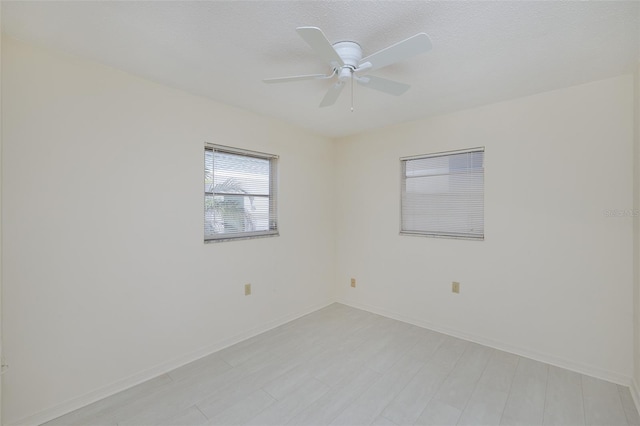 empty room featuring baseboards and a ceiling fan