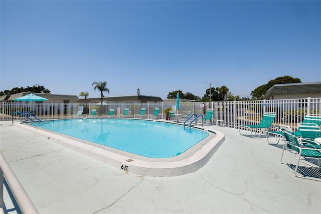 pool featuring a patio area and fence