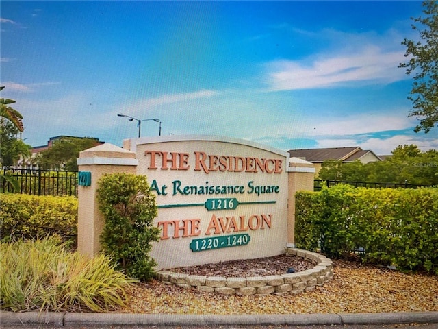 community / neighborhood sign featuring fence