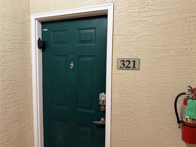 entrance to property with stucco siding