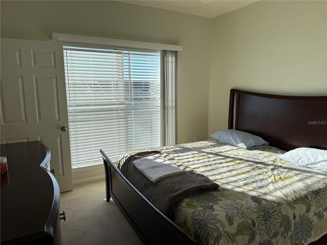 bedroom with carpet flooring and baseboards