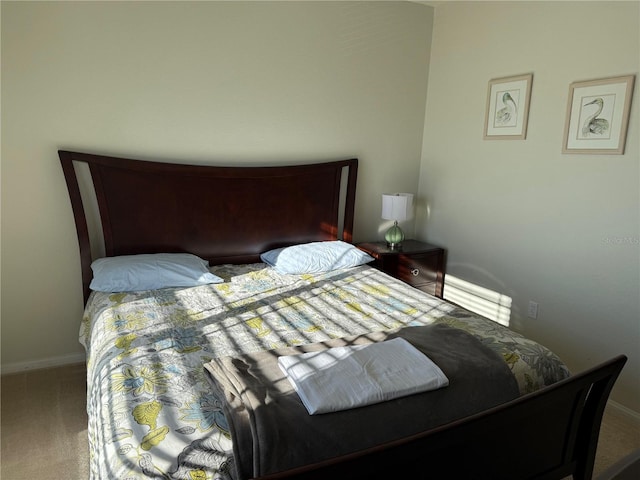 bedroom with carpet floors and baseboards